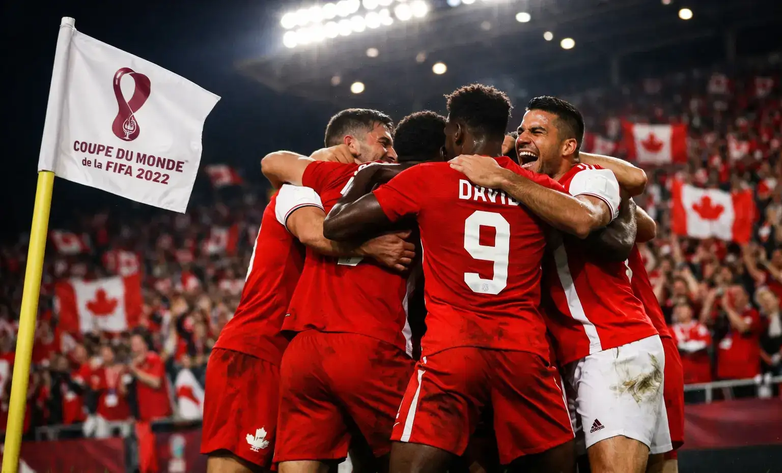 Joueurs de l'équipe nationale du Canada célébrant un but sur le terrain lors d'un match international