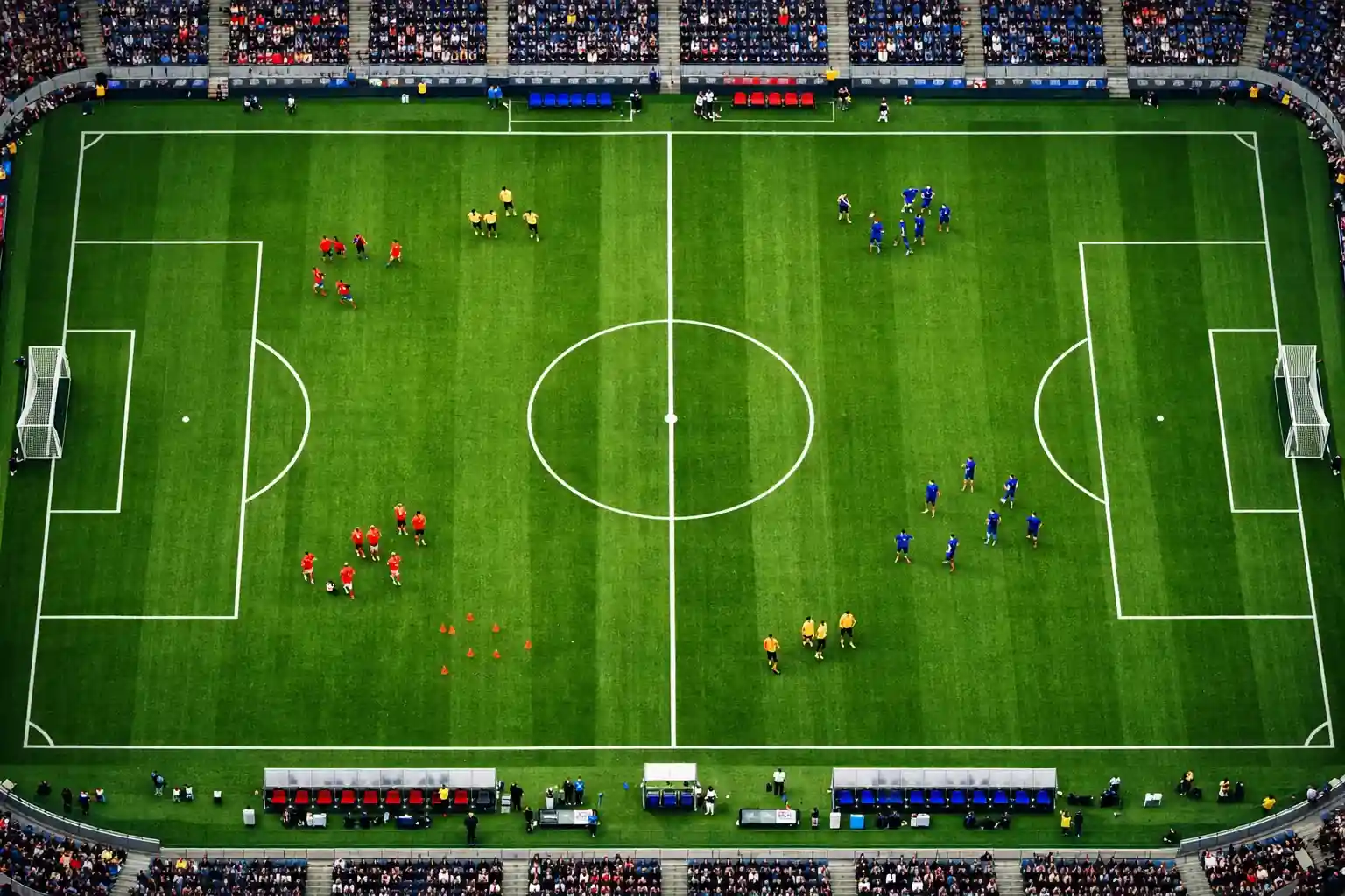 Vue plongeante d'un terrain de soccer avec les cercles et lignes de jeu visibles sous l'éclairage du stade